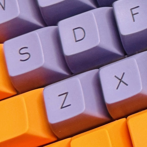 Close-up of colorful keyboard keys with purple and orange keys.