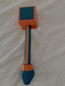 Black and red Hephaestus hammer on a beige background.