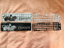 Two Chimera PCBs with plates on a beige surface. One black and white the other white and black.
