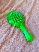 Hera paddle in nylon green on a beige background.