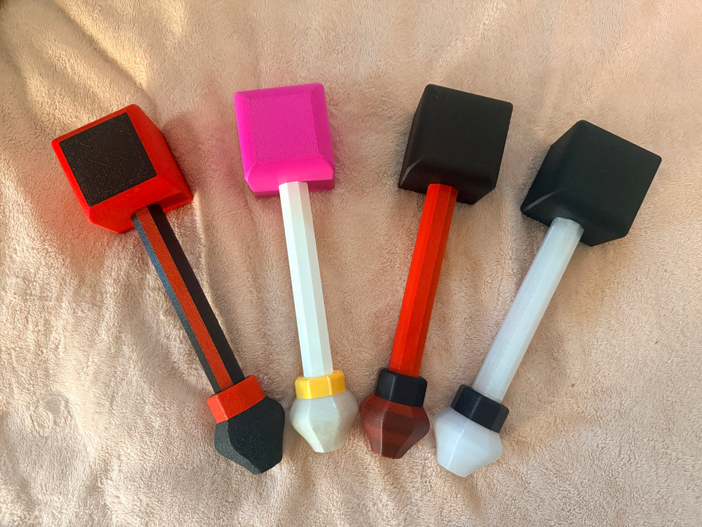 Set of Hephaestus hammers in a variety of colors on a beige background.