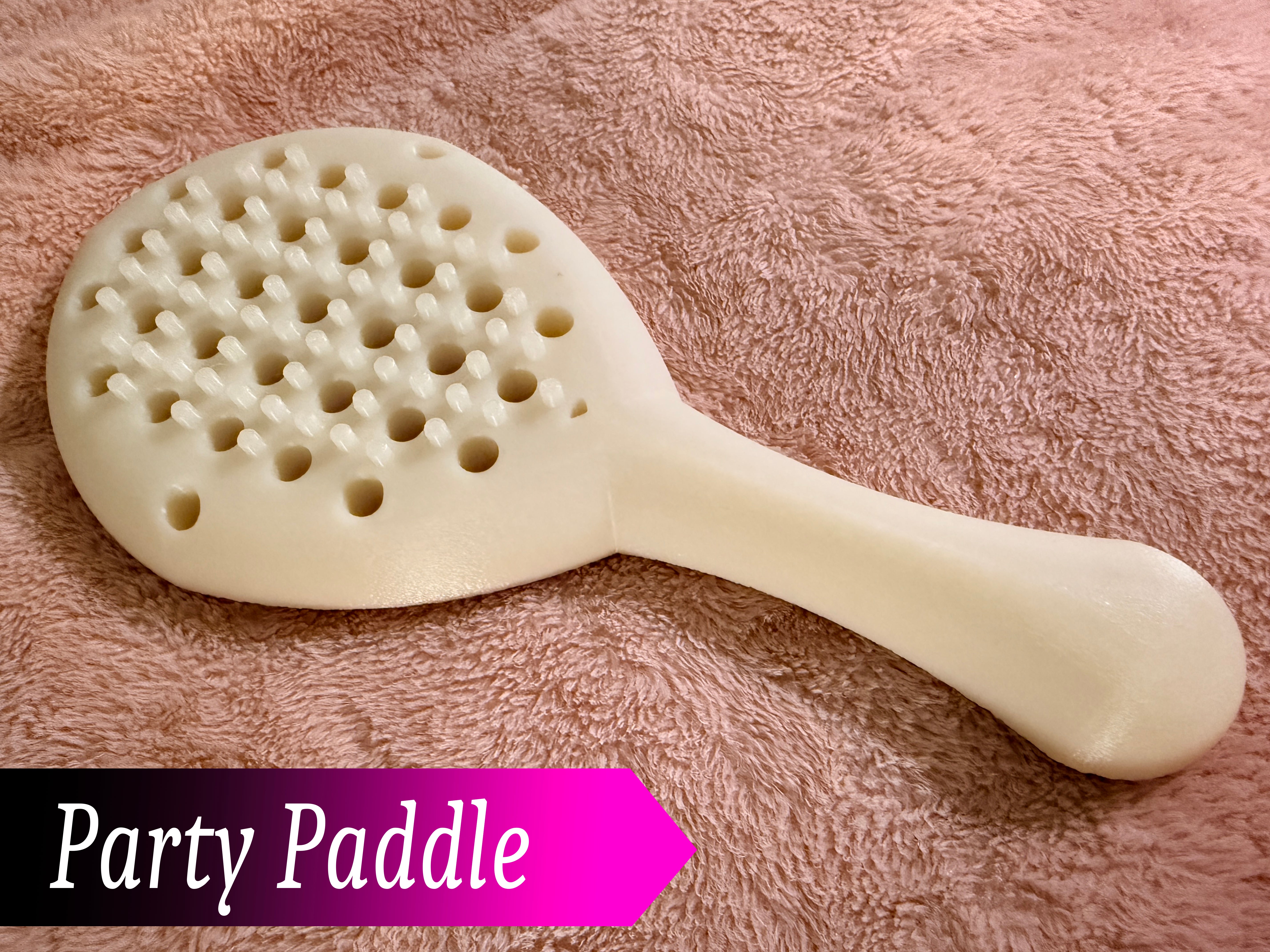 Party paddle in white on a brown background.